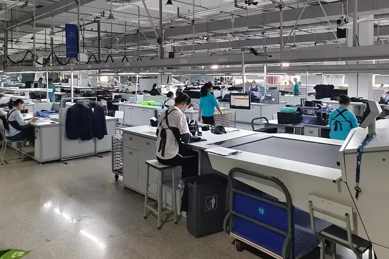 Inspector checking custom shirt measurements during production